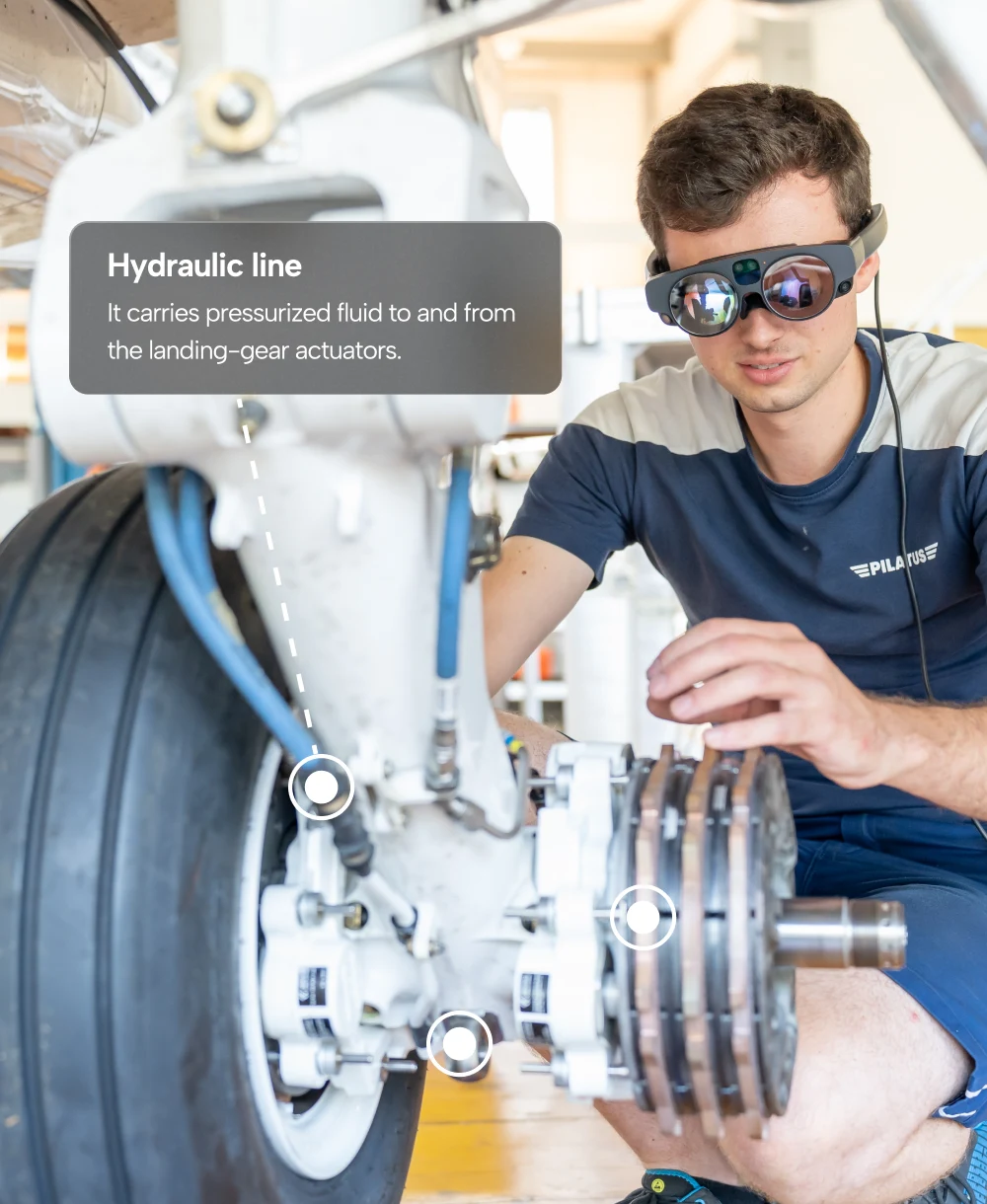 a man using AR headset for airplane maintenance work