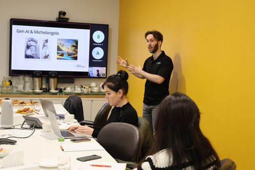 A woman and a man sitting and having a discussion about technology