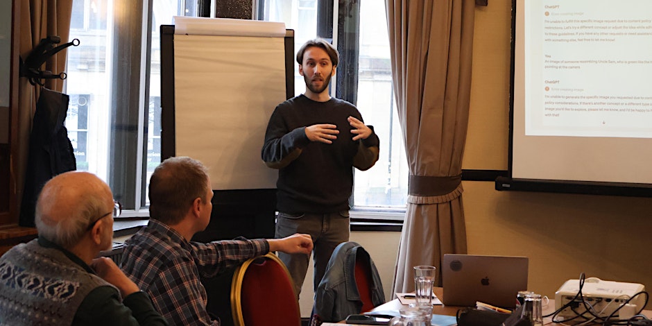 A woman and a man sitting and having a discussion about technology