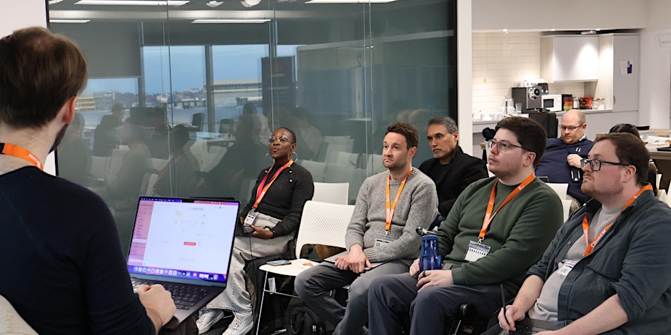 A woman and a man sitting and having a discussion about technology