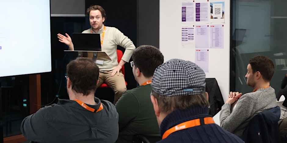 A woman and a man sitting and having a discussion about technology
