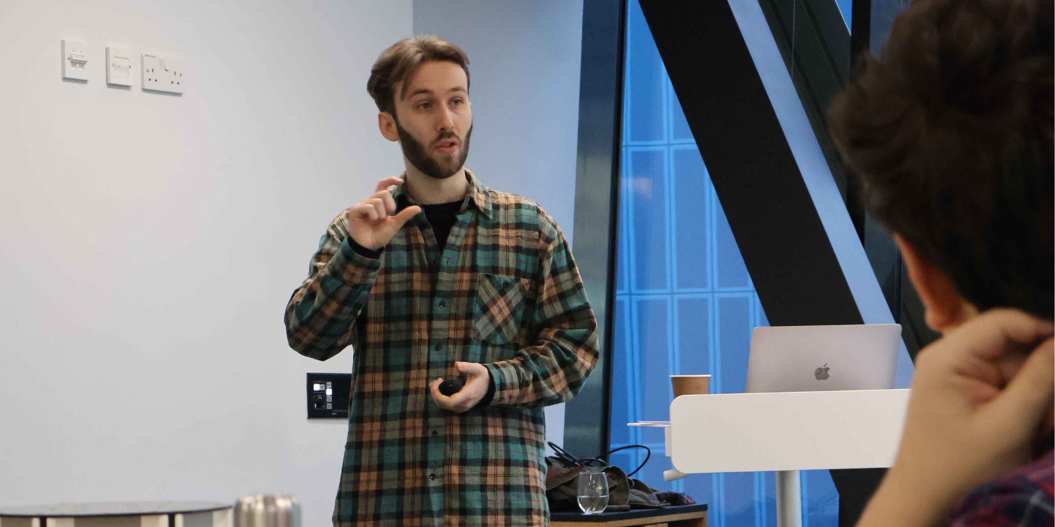 A woman and a man sitting and having a discussion about technology