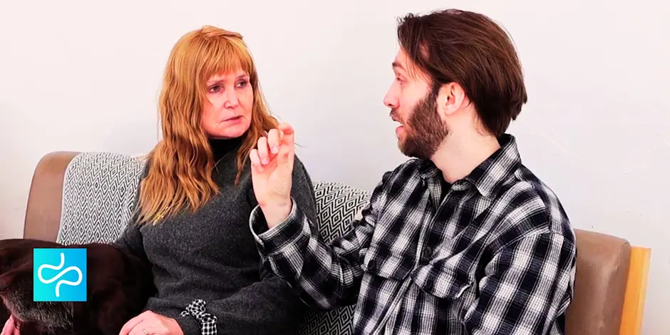 A woman and a man sitting and having a discussion about technology