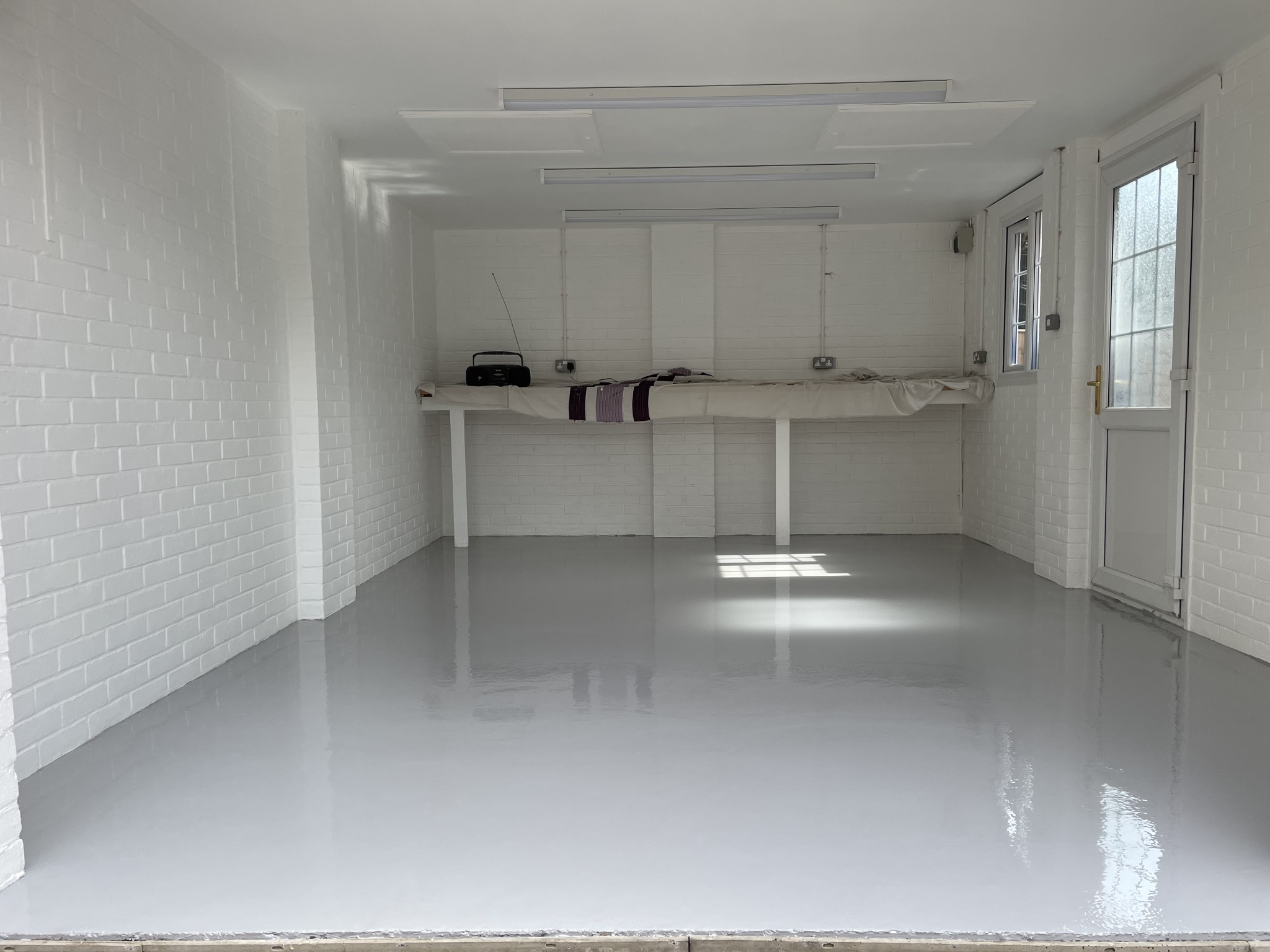 Light grey solid colour epoxy garage floor installed by Garage Upgrade in Southampton