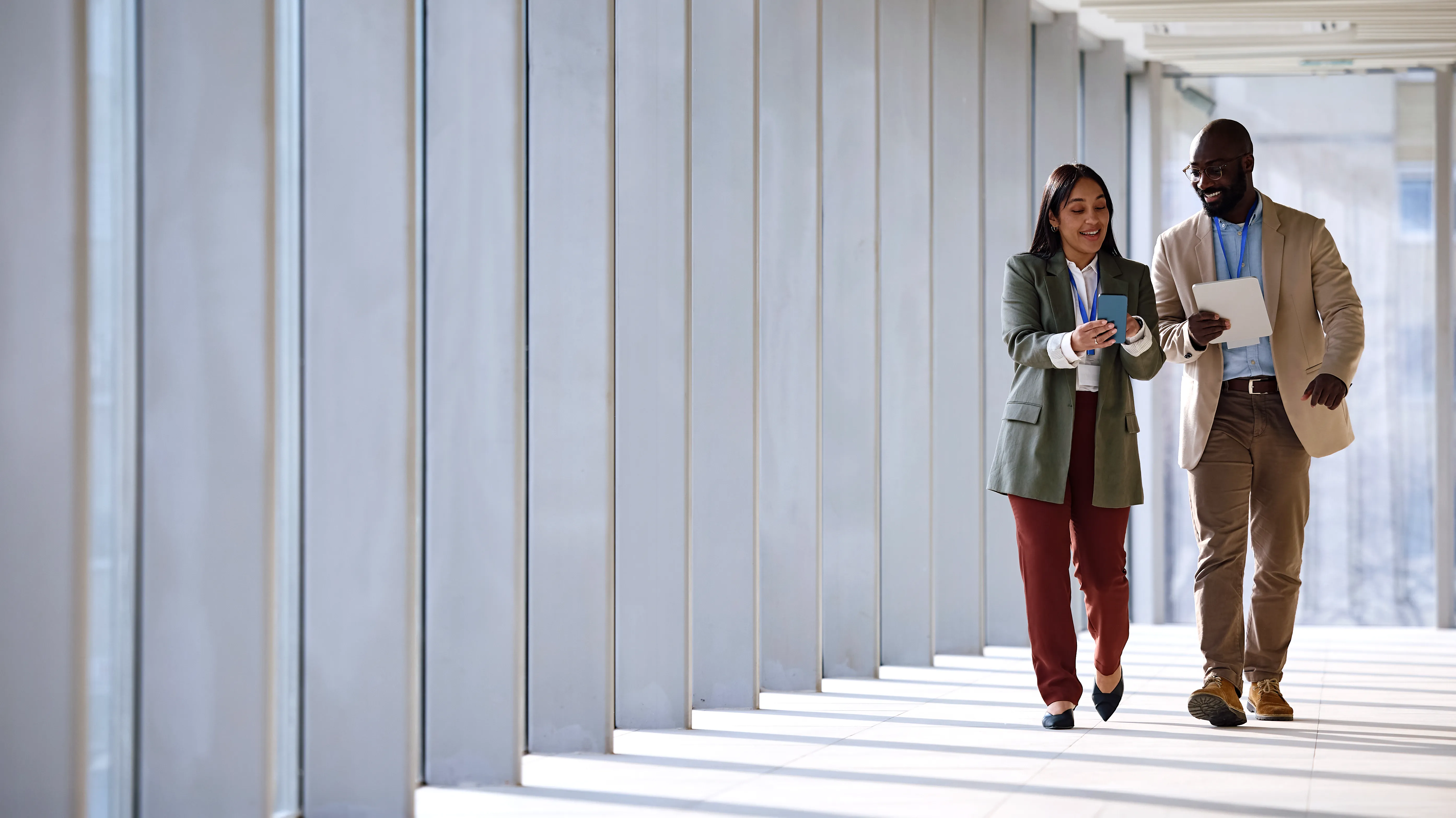 Two real estate professionals walking and talking over a phone screen