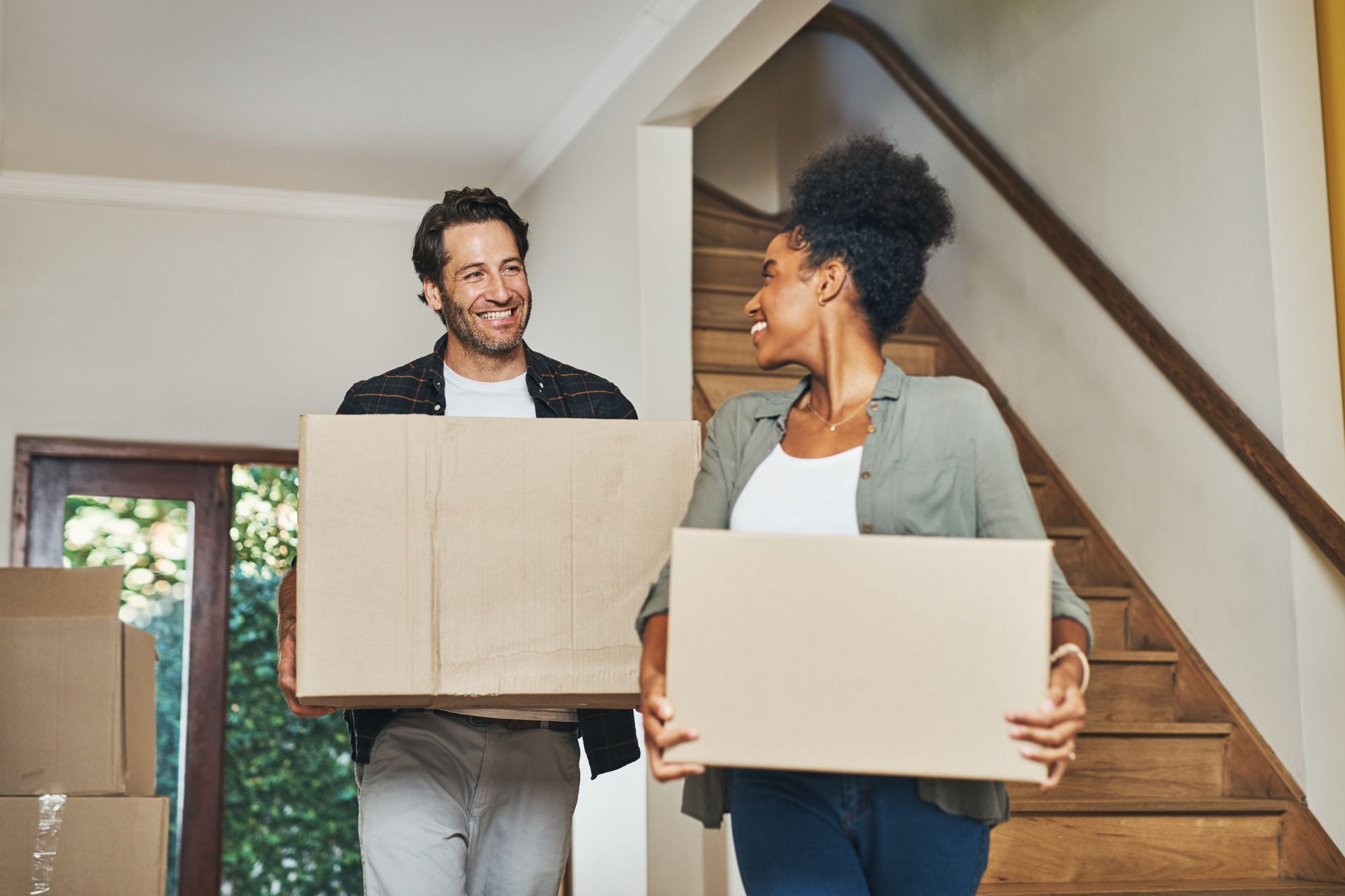 First-time home buyers moving into a new home, representing closing risks and costs before getting the keys