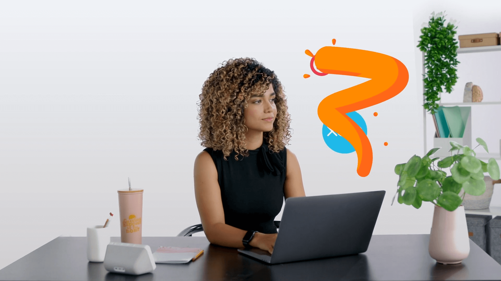 A woman at a desk with a laptop