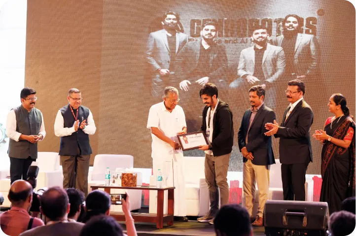 a photo in which team gen robotics receive award from state goverment