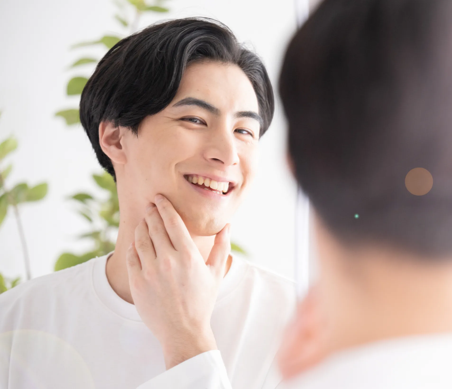 Man looking at treatment results in the mirror