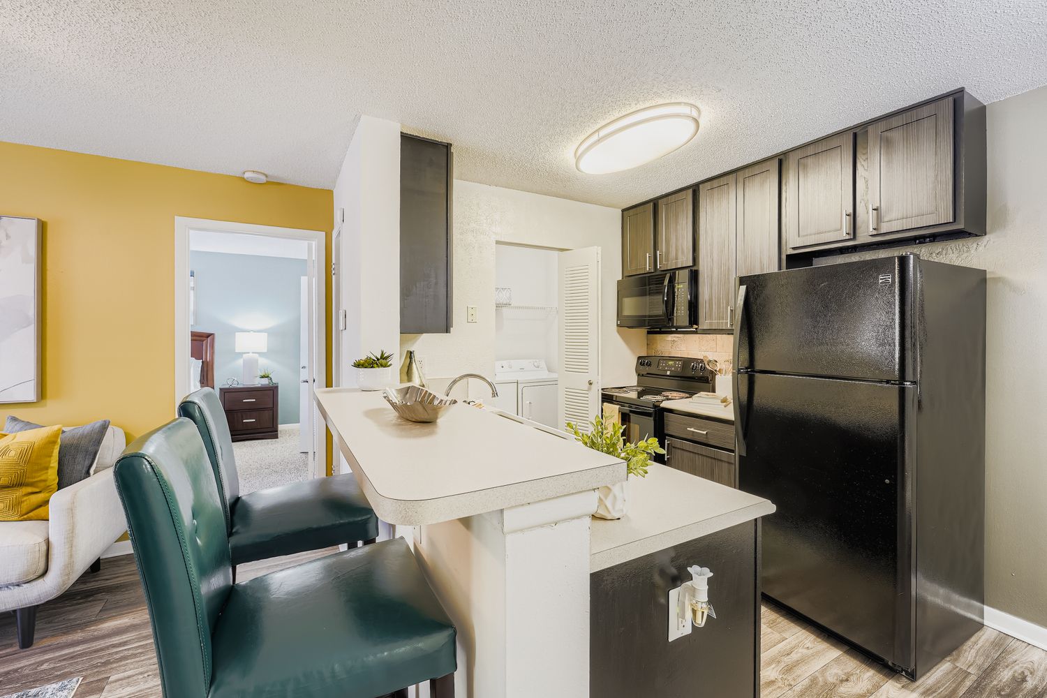 view of furnished bedroom, kitchen, and living area