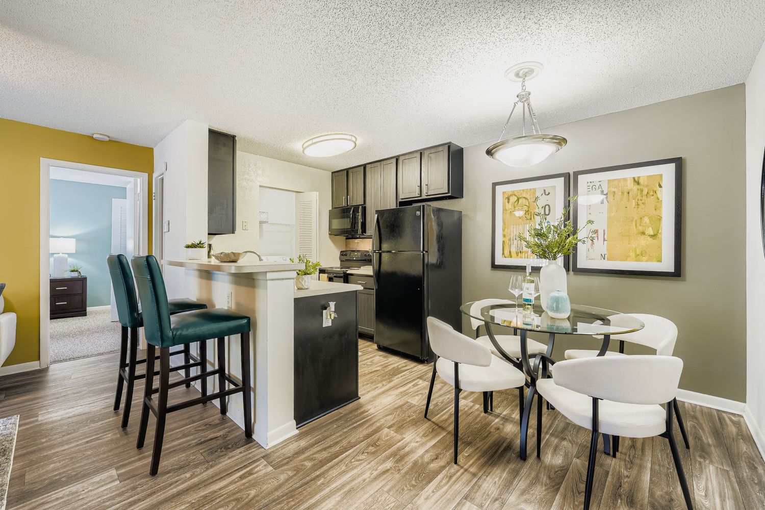 view of furnished bedroom, kitchen, and living area