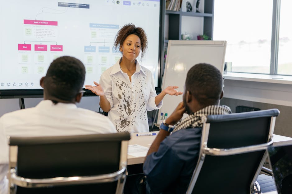 A sleek, modern office scene showing a diverse team engaged in a call management strategy session, with digital screens and call-flow diagrams visible.