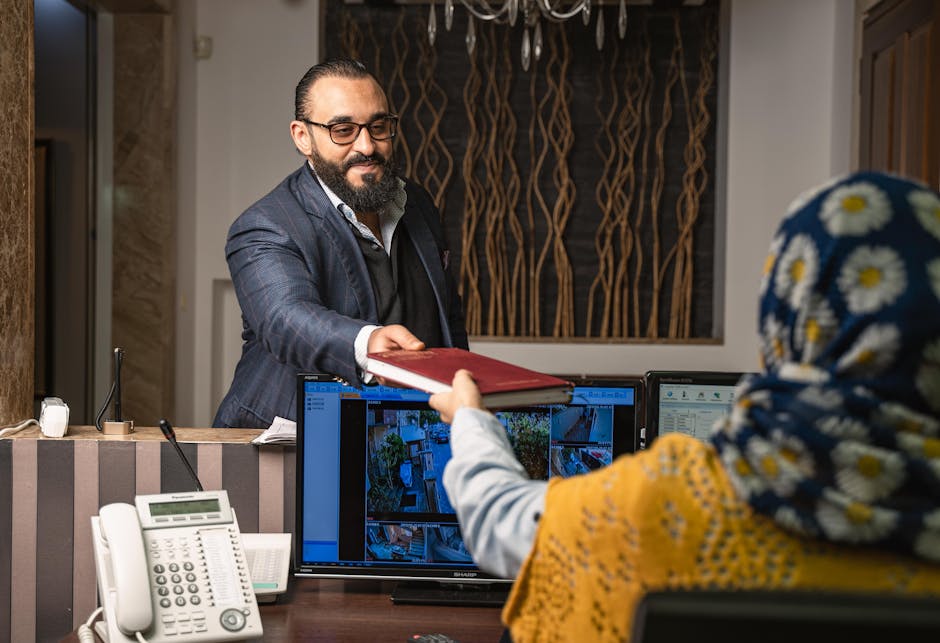 An office with employees collaborating using modern communication tools, with screens showcasing a computer phone program in action.