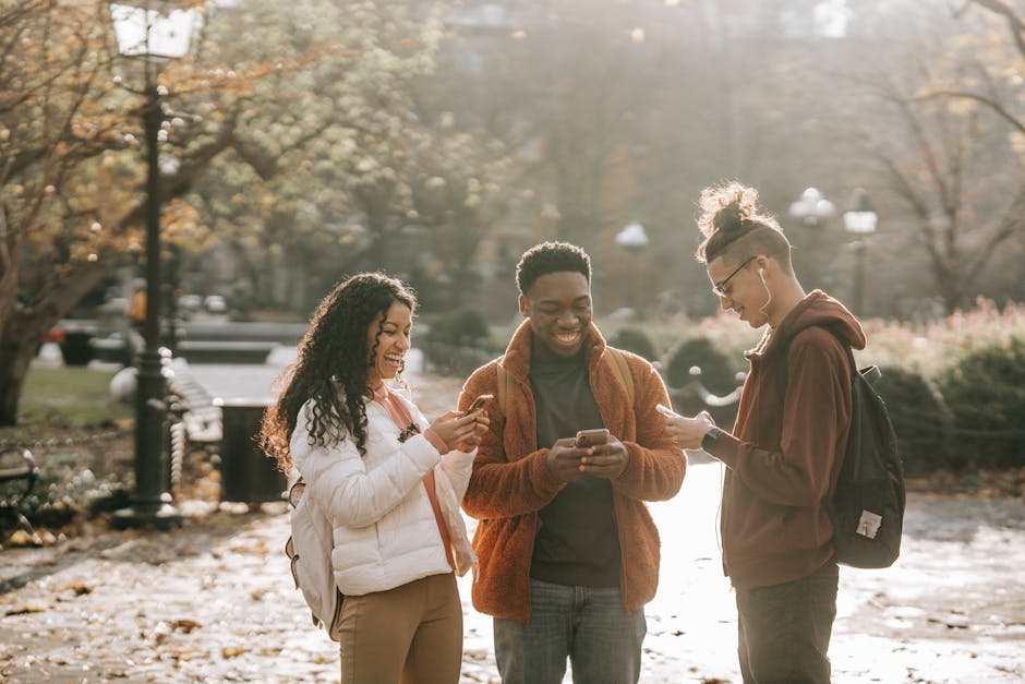 A diverse group of people laughing while on the phone outdoors, representing the light-hearted nature of unexpected phone calls.
