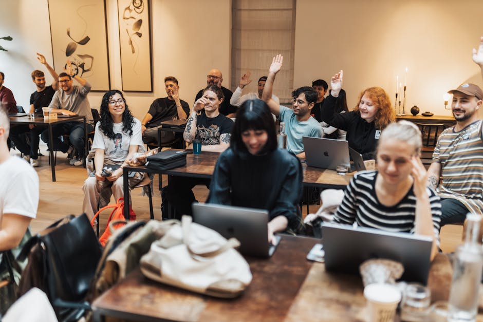 A diverse group of professionals engaging in a training session focused on AI receptionist solutions, with laptops open and interactive screens displaying messaging interfaces.