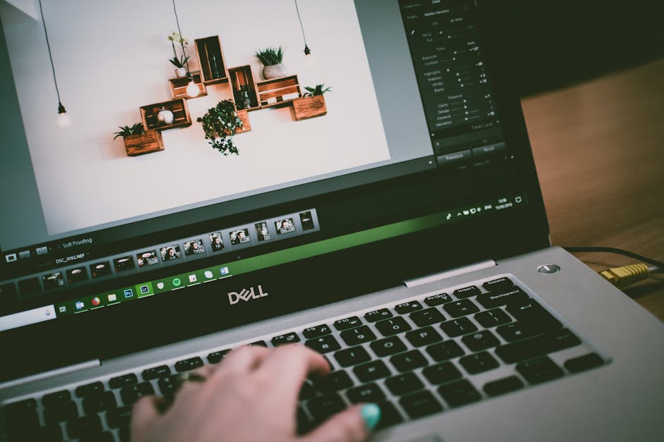 A dynamic workspace setup with a focus on productivity, featuring a phone, a laptop with organized tabs, and inspirational quotes on the walls.