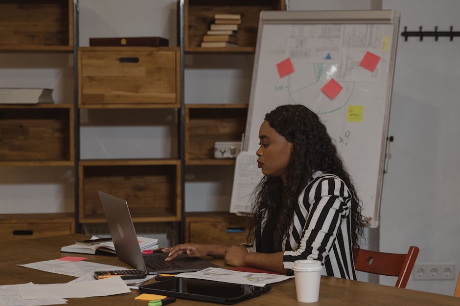 A creative representation of a busy office environment where a person is skillfully answering a phone call, using a headset, surrounded by notes and a computer.