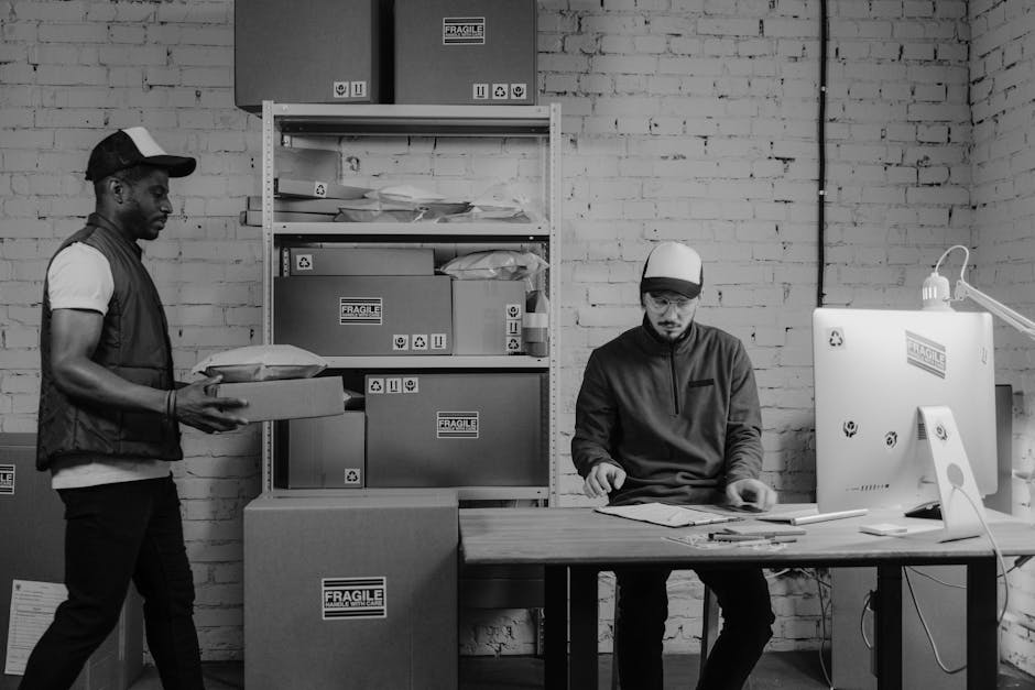 A sleek, modern office with employees engaging in customer service, showcasing a branded phone system on the desk.