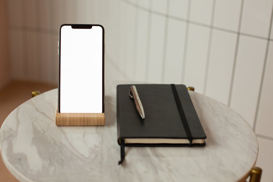 A sleek smartphone displaying Voicemail Forwarding features in an office setting