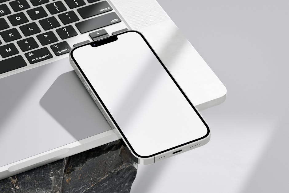 A modern office setting with a laptop displaying Ooma interface, highlighting the voicemail download process.