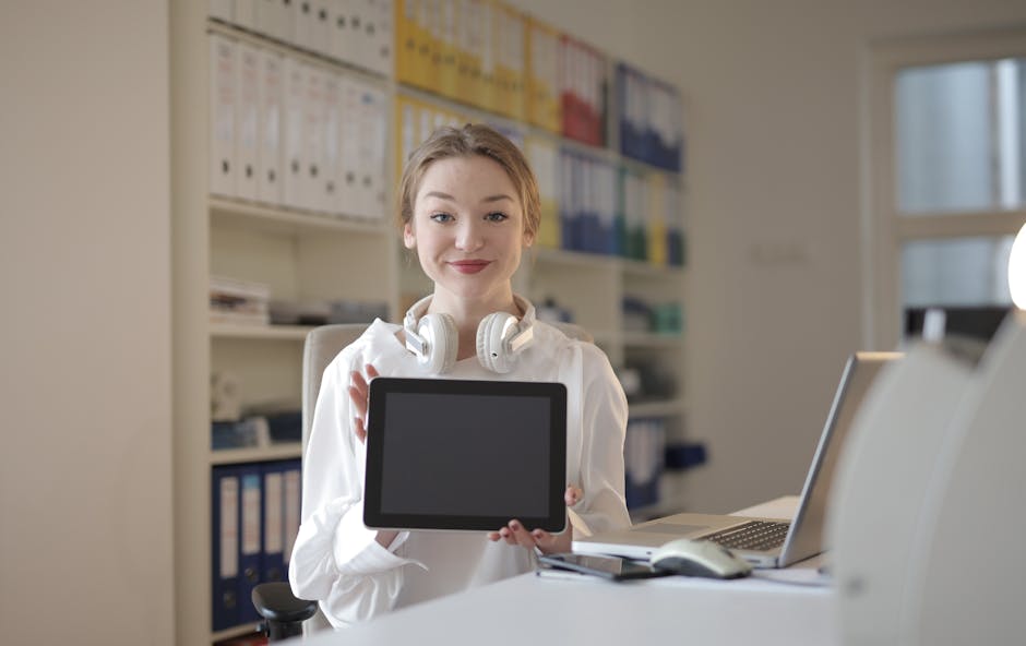 A vibrant office setting showing a receptionist engaging with a caller while using advanced technology.