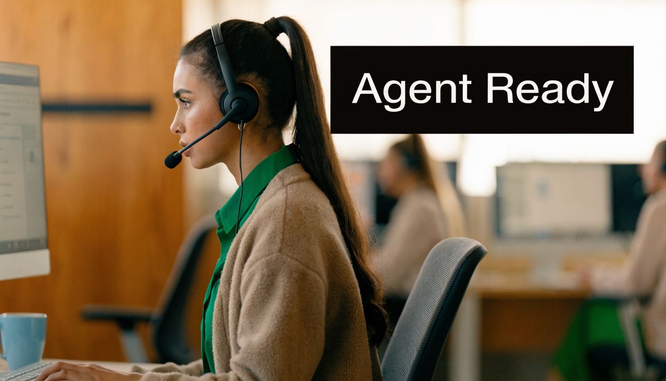 A professional customer service representative wearing a headset, working at her computer in an office environment.