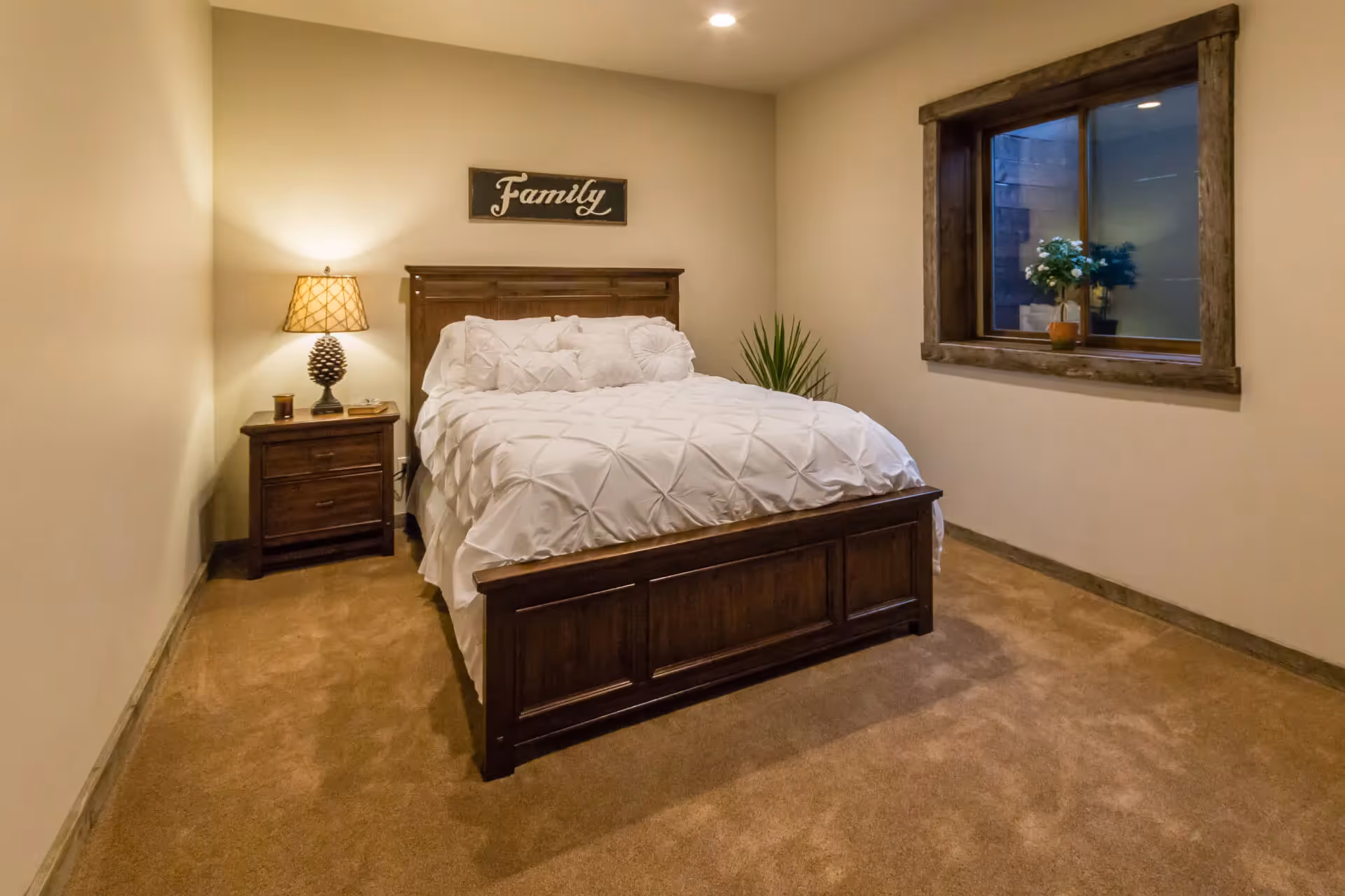 A basement bedroom with a large egress window