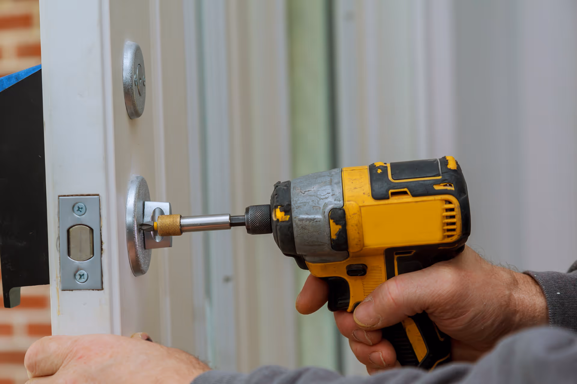 A lock being installed on a door.