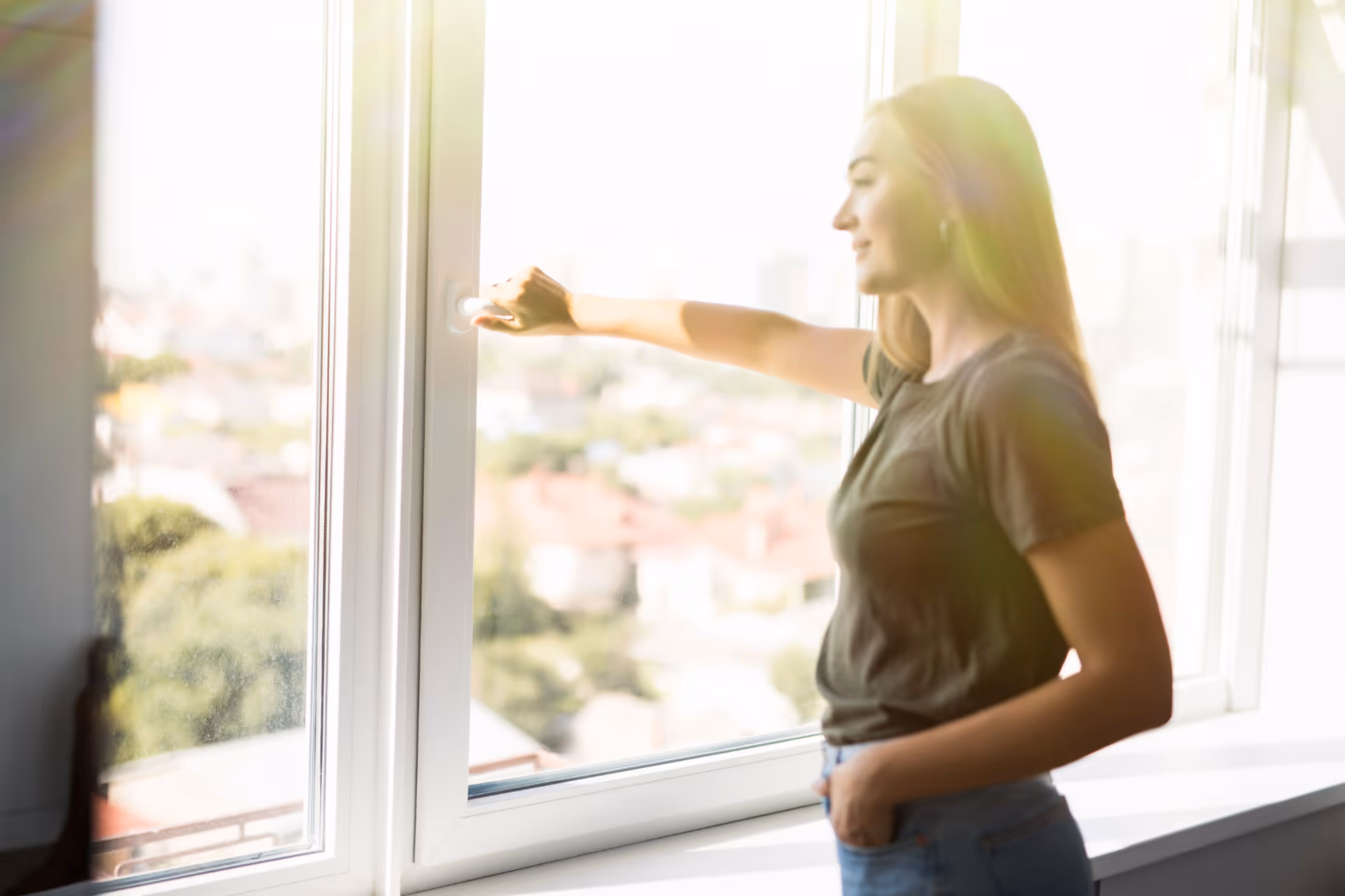 A woman opening a casement window.