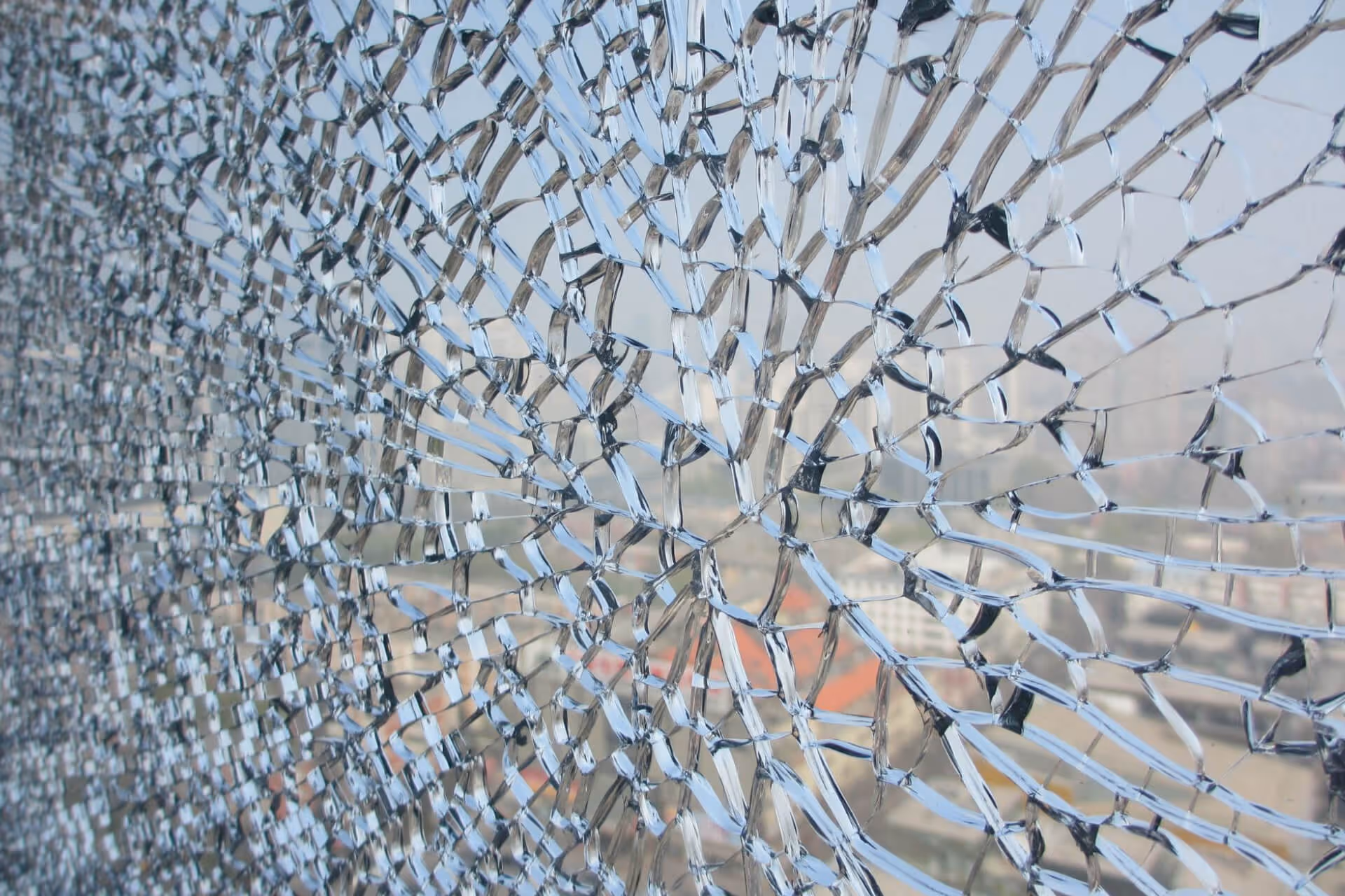 Shattered laminated glass still retaining its shape in the panel