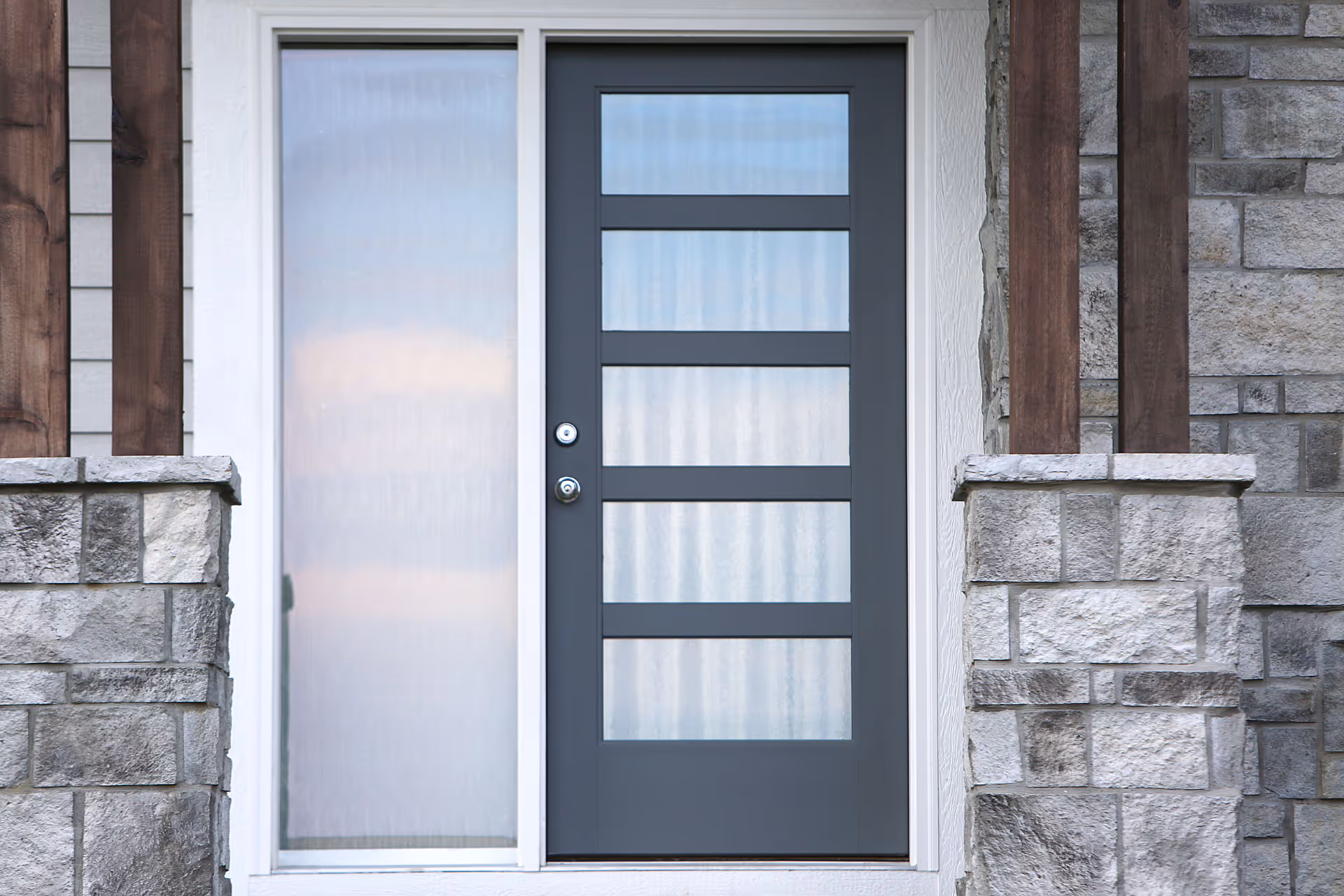 Ontario home with a black front door in a modern door style with multiple clear glass panes