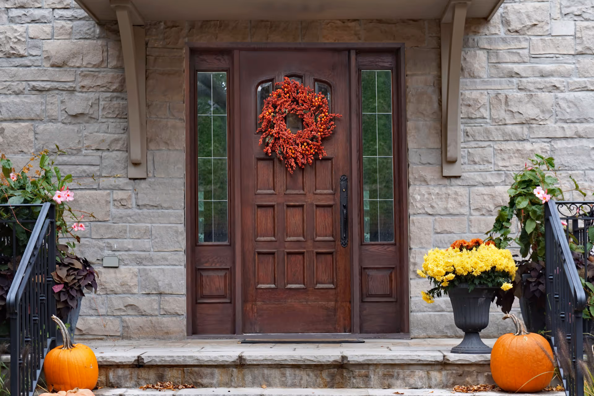 Front entrance of an Ontario home featuring a rustic front door decorated for autumn with a seasonal wreath