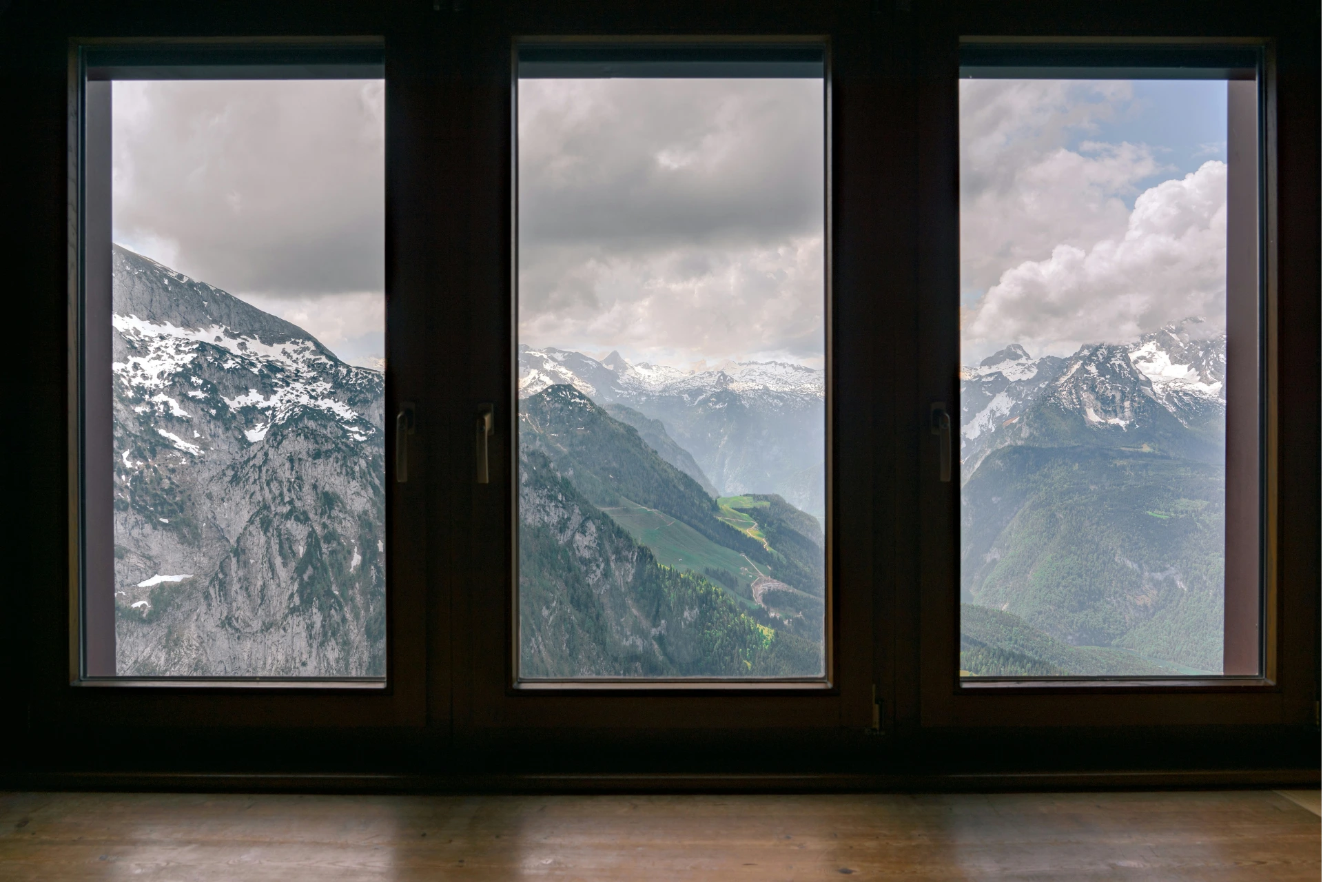 the view of foggy mountains beyond a window