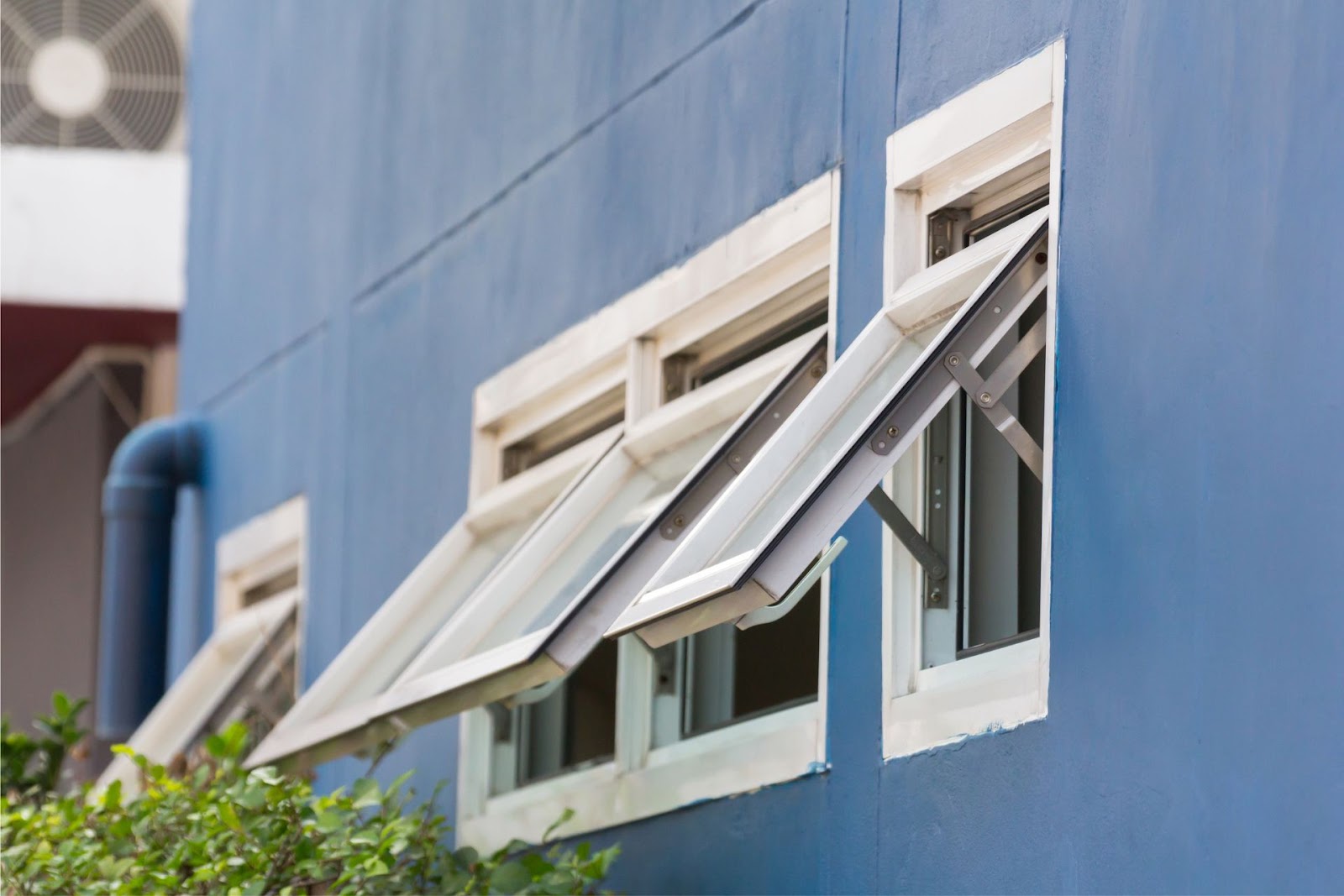 Open awning windows in a home.