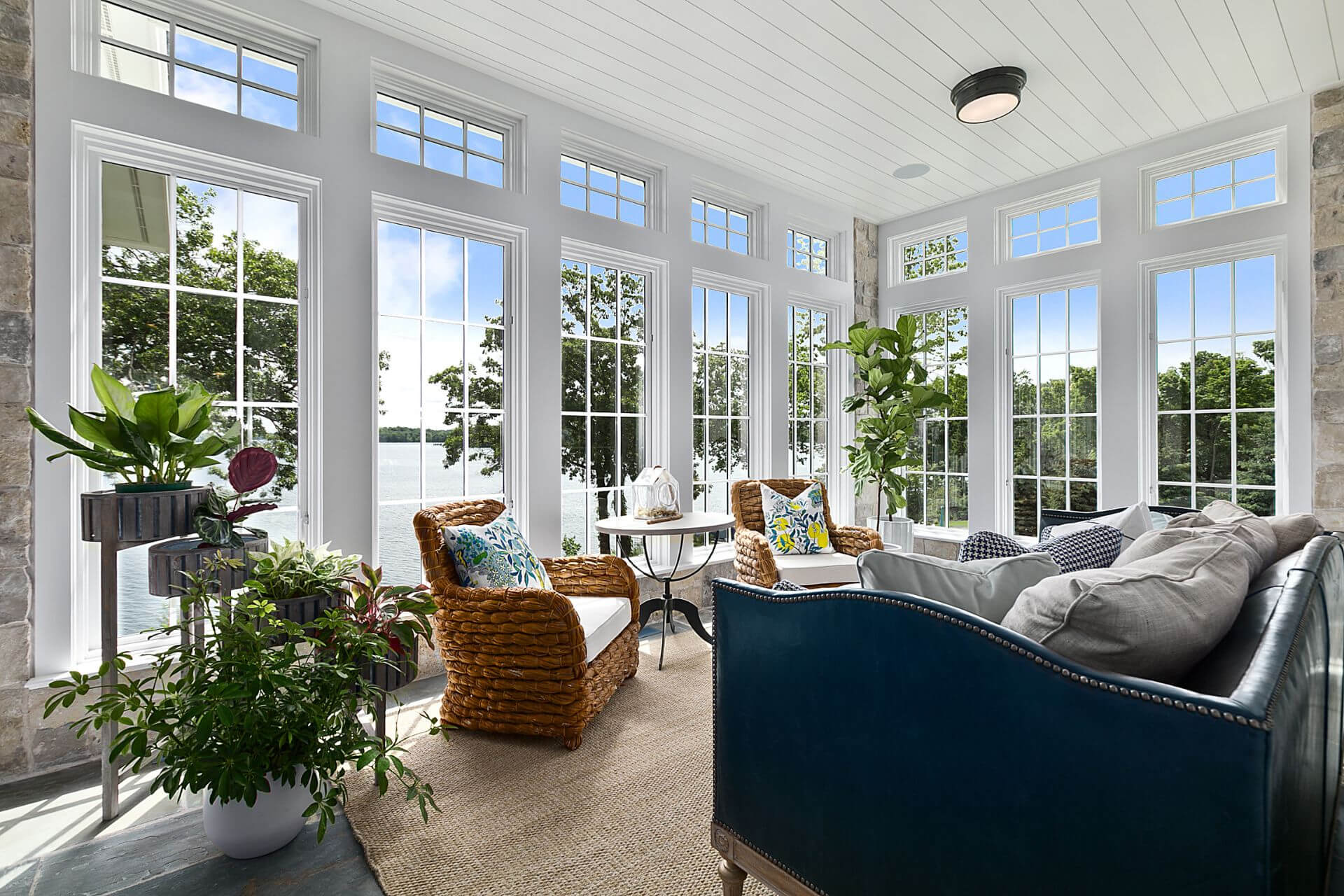 A bright living room space with floor-to-ceiling windows