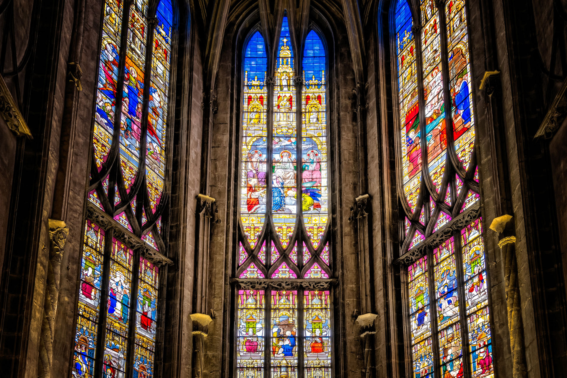 Numerous stained glass windows inside a church