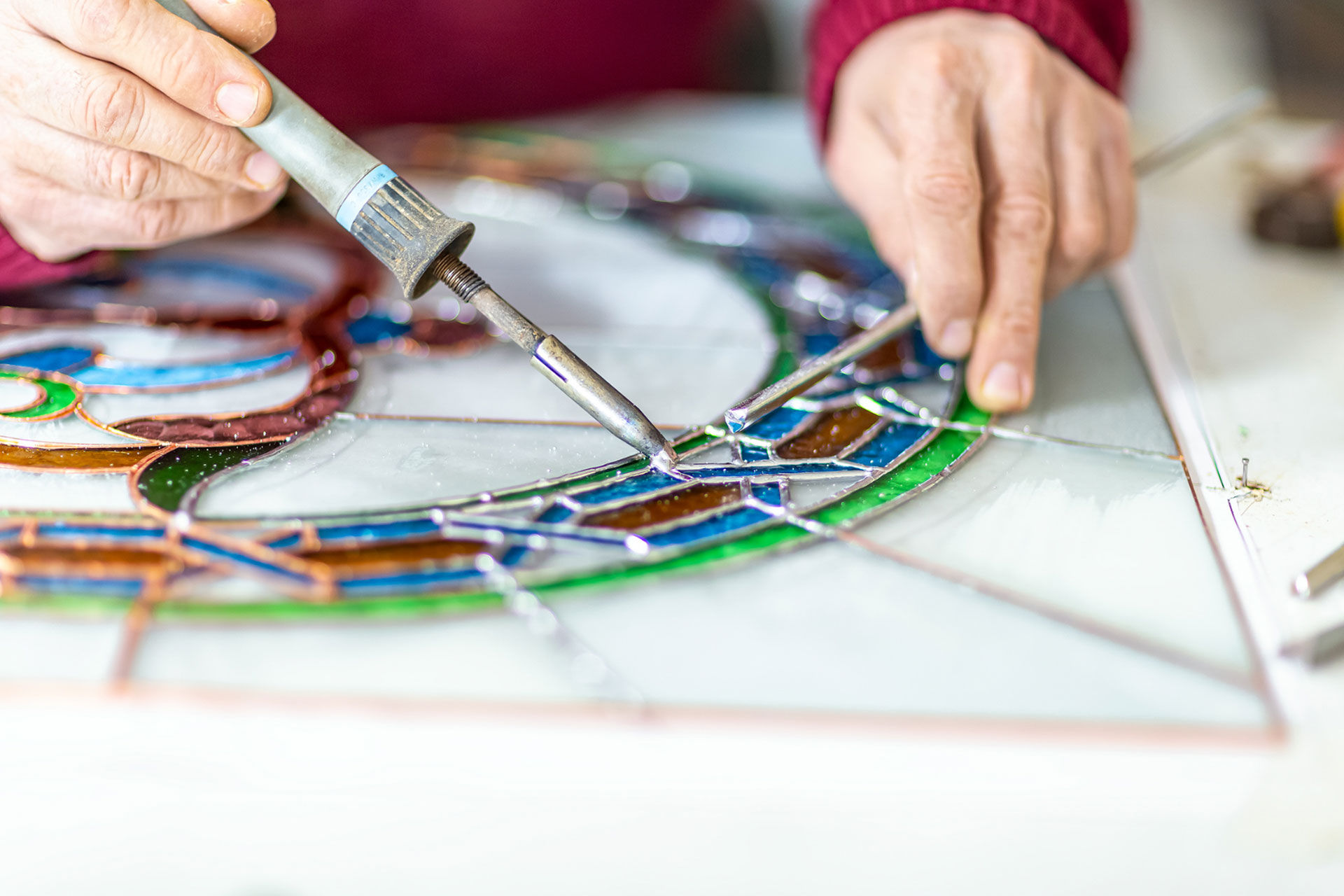 Person creating stained glass windows