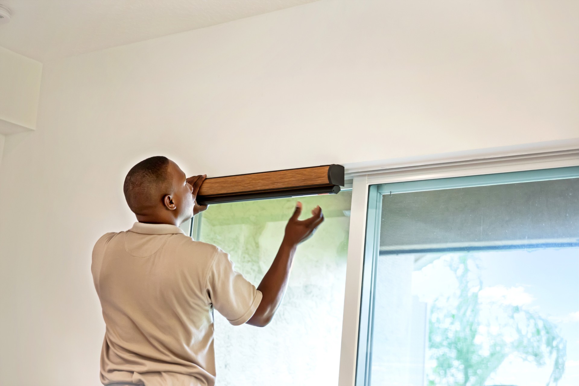 Person installing window blinds