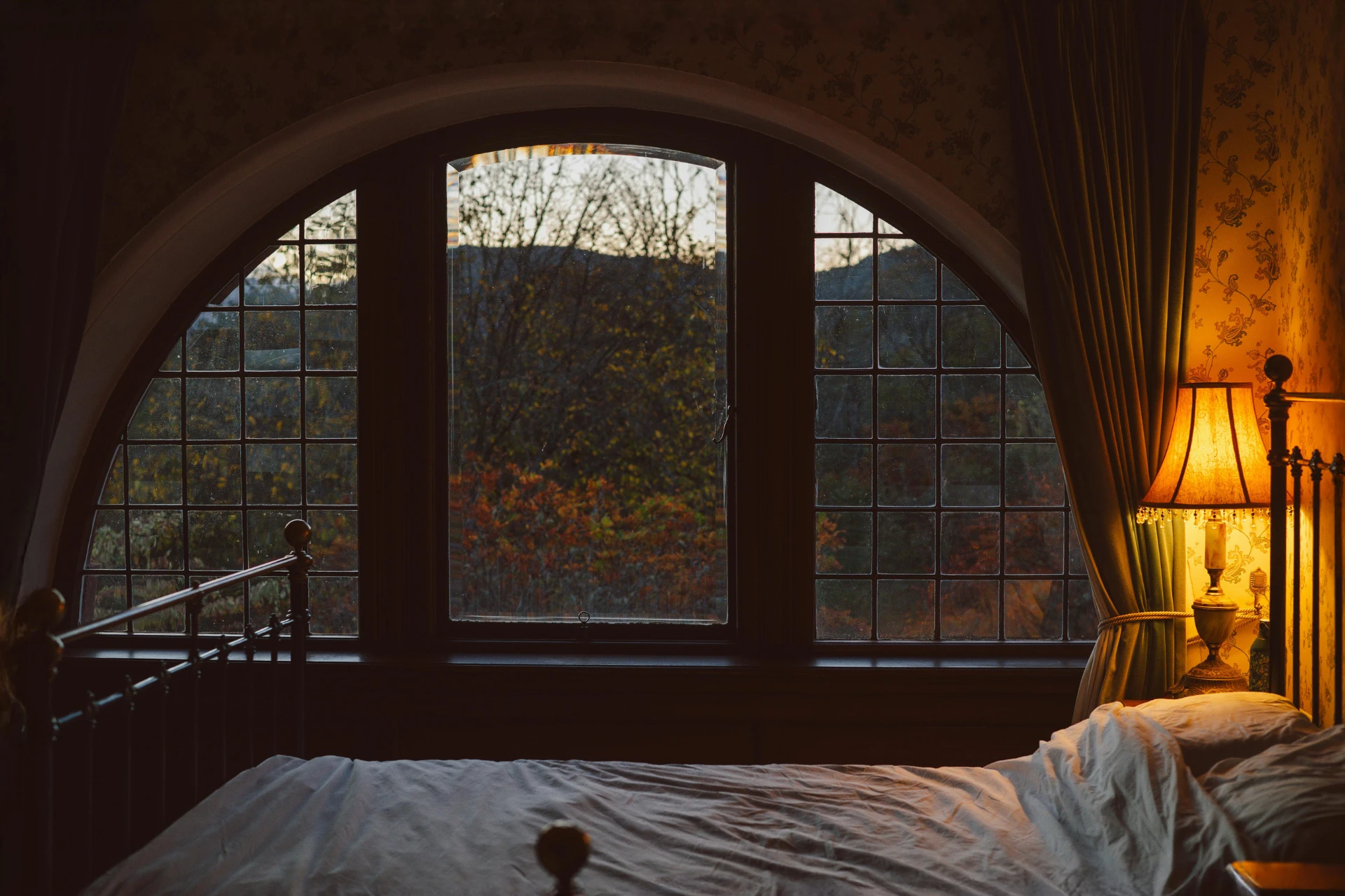 Cozy room with a domed window design, lit by a lamp