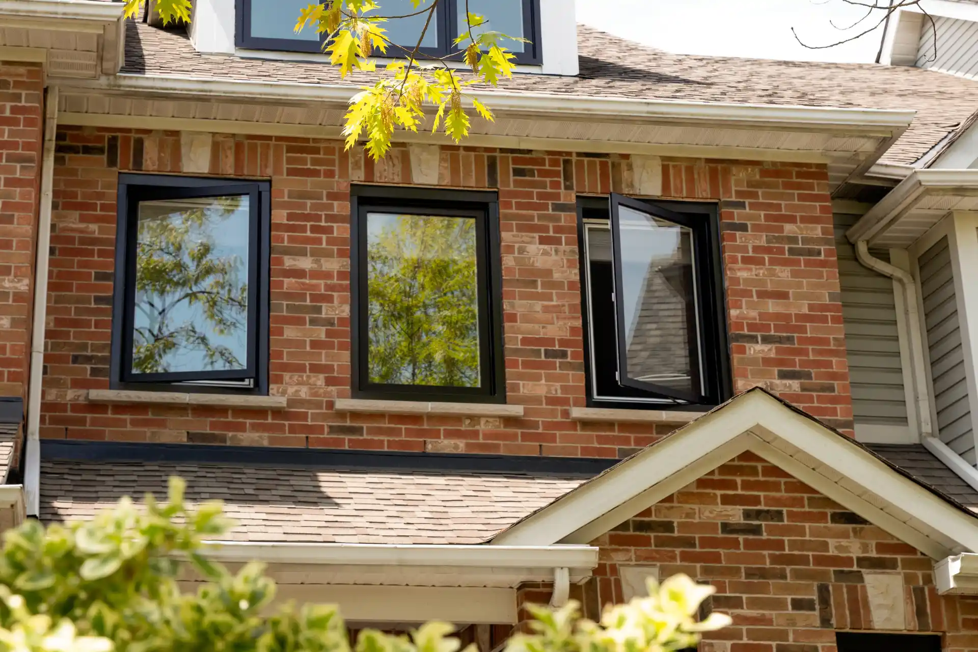 Clera Windows + Doors casement windows with black window frames on the second floor of a home 