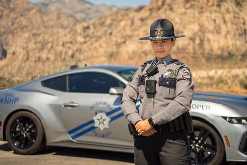 female officer in front of car
