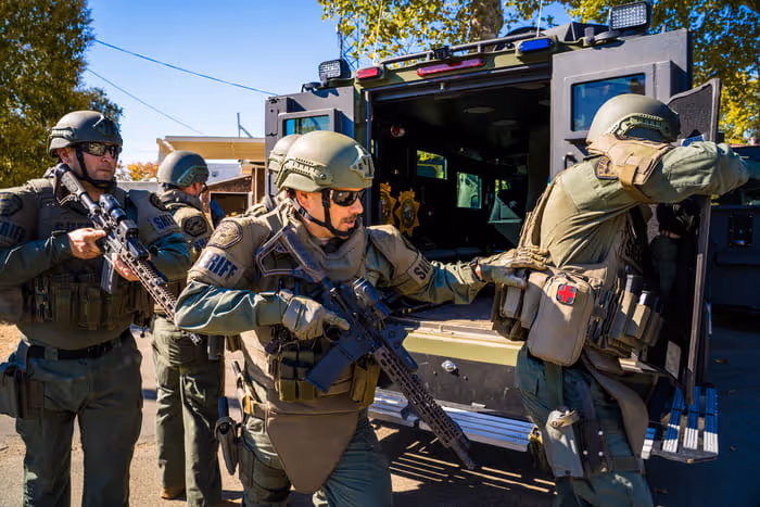 swat officer coming out from the truck