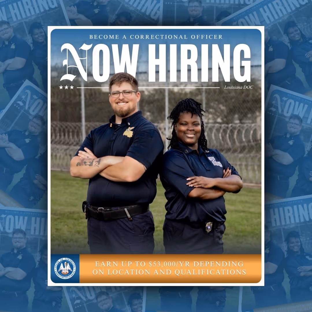 Two correctional officers in dark uniforms stand back to back with arms crossed in front of a barbed wire fence. Text reads 'Become a Correctional Officer NOW HIRING Louisiana DOC. Earn up to $53,000/yr depending on location and qualifications.'
