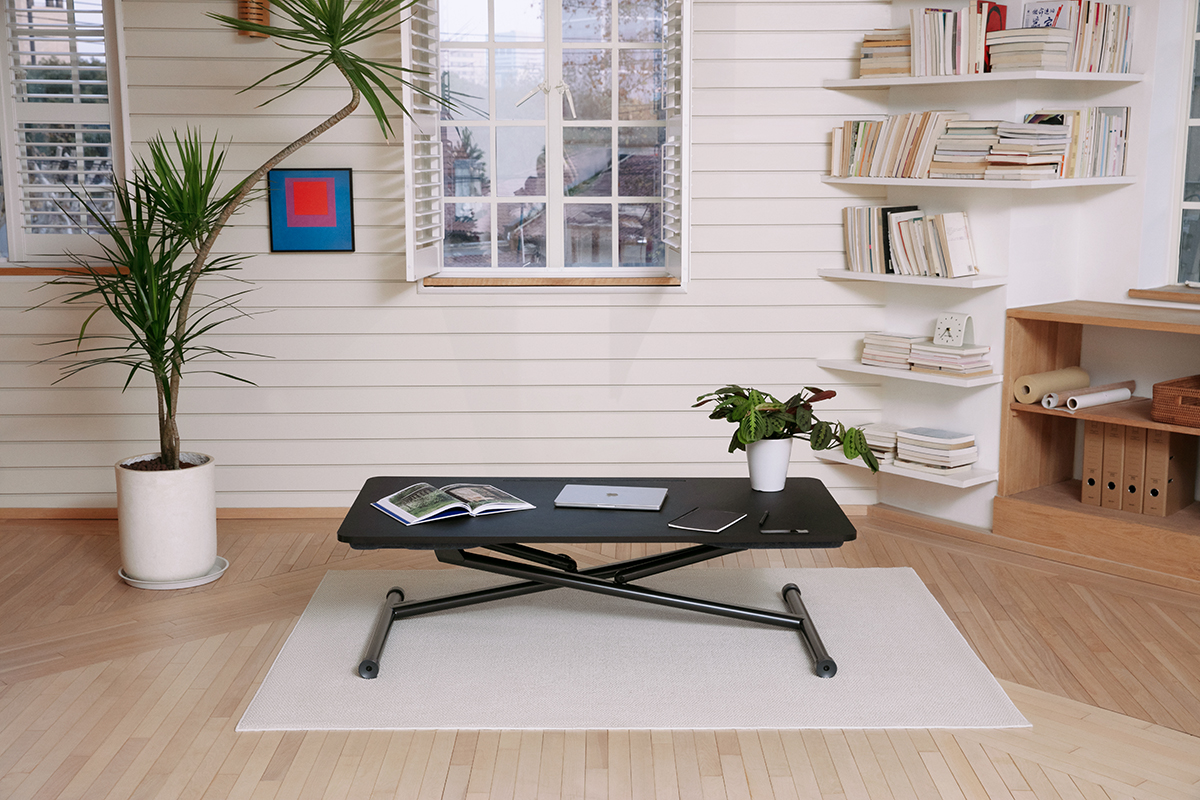 Black marinamantra flow desk in a brightly lit room