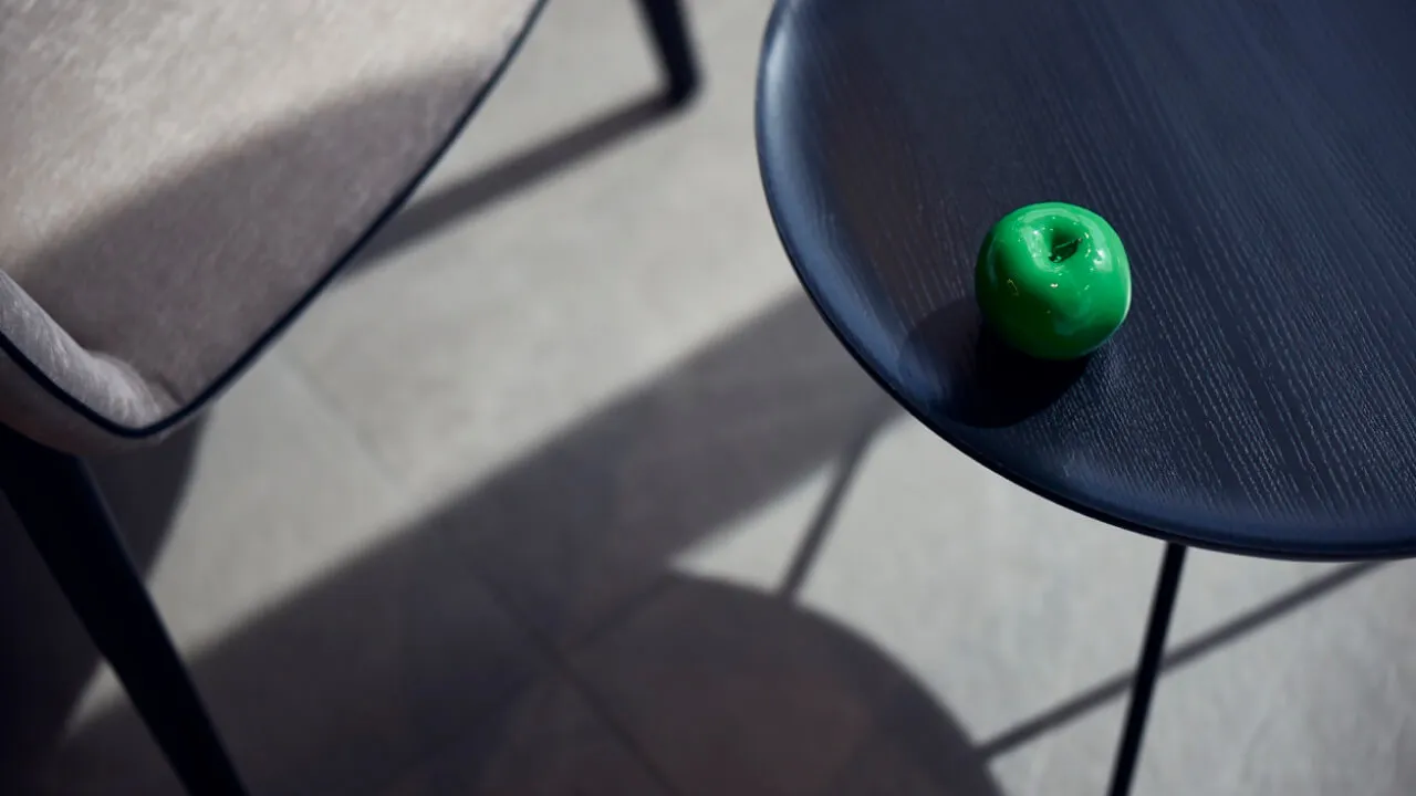 A green apple sitting on a table