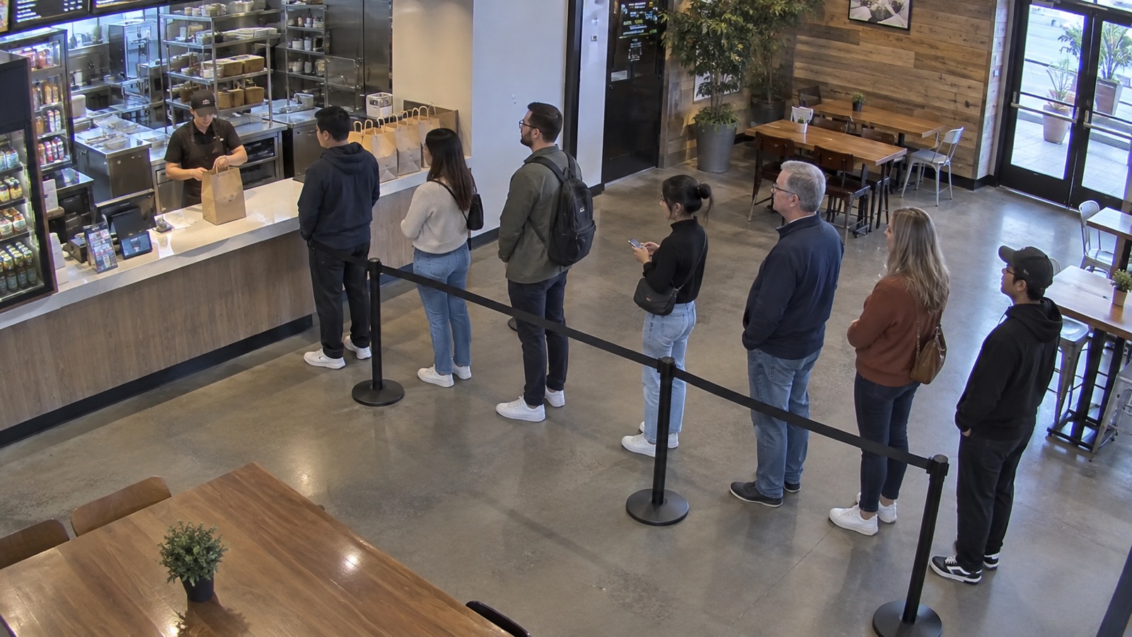 Security camera view of customers waiting in a restaurant queue