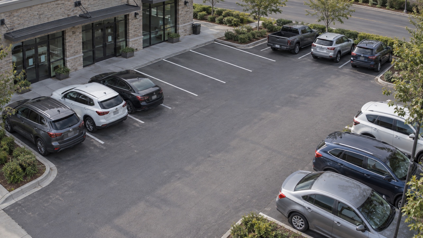 Security camera view of a parking lot with available spaces