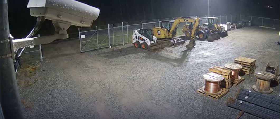 An equipment yard at night, used as an illustrative notification attachment.