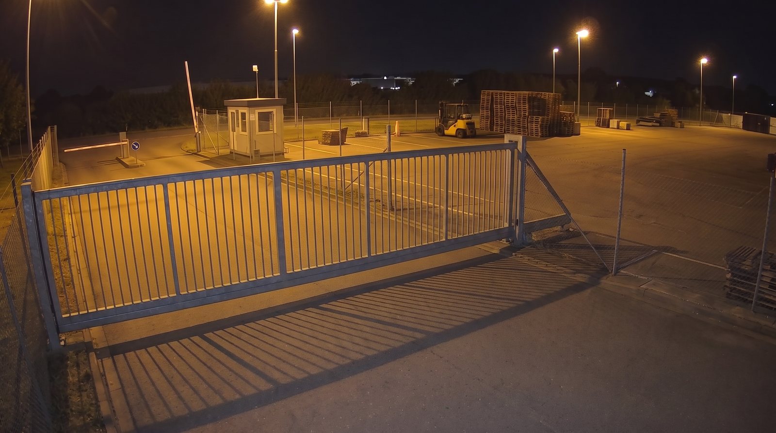Yard gate at night, closed: the panel runs across the road