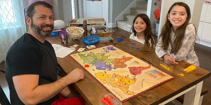 family playing board game at table